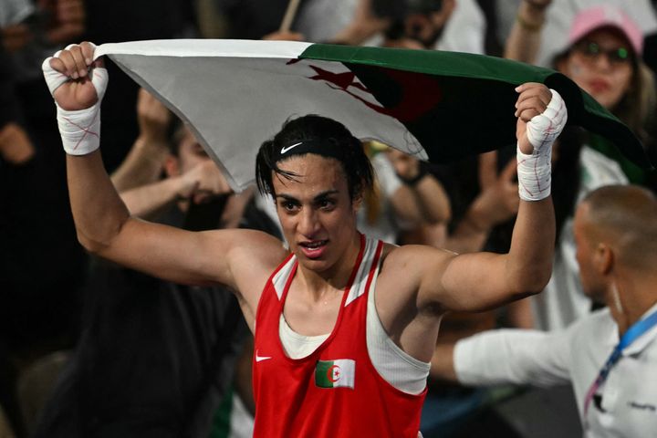 Algeria's Imane Khelif reacts after beating China's Yang Liu (Blue) in the 66kg boxing final during the Paris 2024 Olympic Games at the Roland-Garros Stadium in Paris on August 9, 2024.