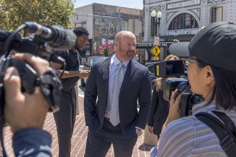 Mathew Bowyer, center, Southern California bookmaker, arrives in federal court in Santa Ana, Calif., Friday, Aug. 9, 2024. (AP Photo/Damian Dovarganes)